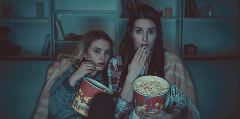 Why Serial Killers & True Crime Stories Are So Fascinating, According To A Psychologist two people holding pop corn , looking scared