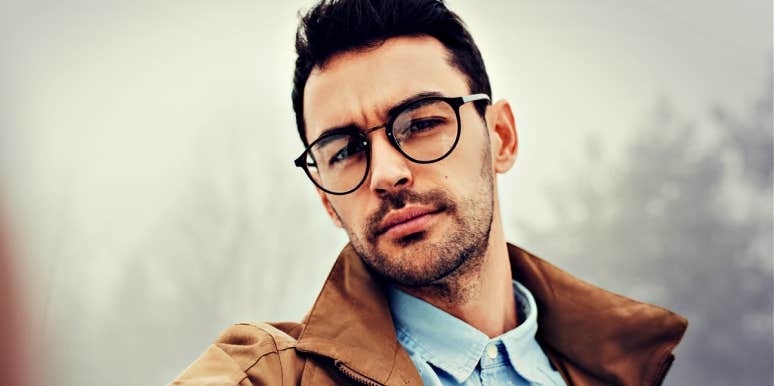 man with glasses, looking serious 