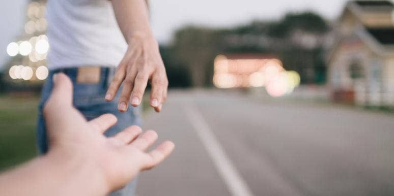 What You Need To Understand About Holding On And Letting Go woman letting go of the hand she was holding onto