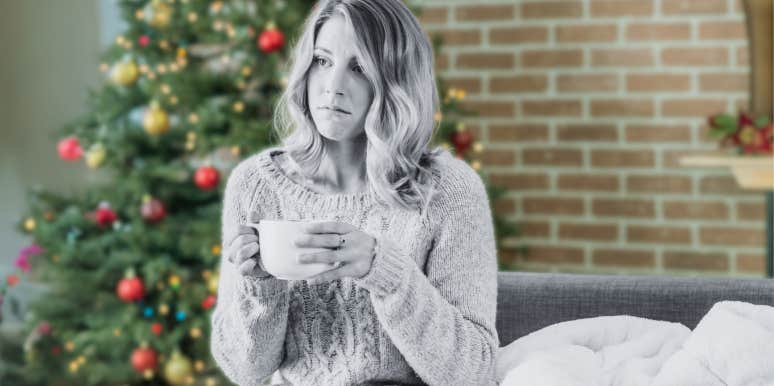 Sad woman in front of Christmas tree