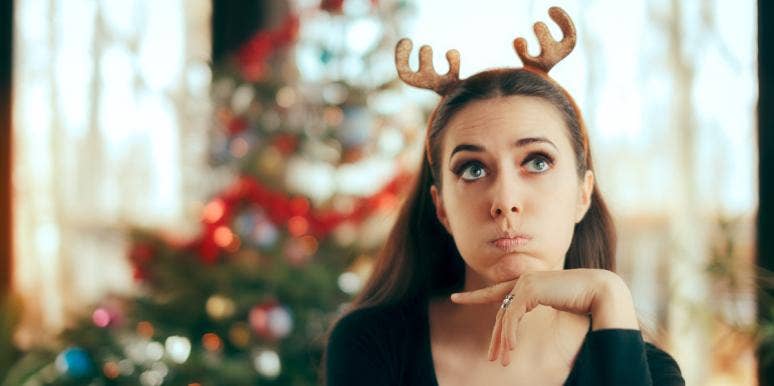 holiday stress tips woman wearing antlers celebrating Christmas