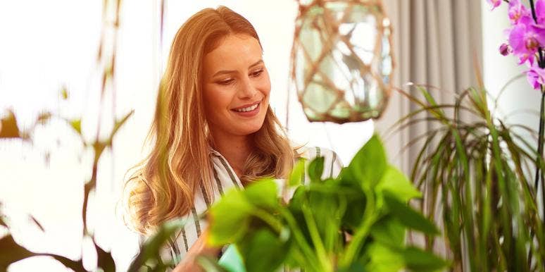 How Your Houseplants Reveal If You're Ready For A Relationship woman watering houseplants