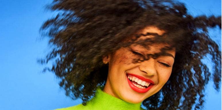 How To Attract Men: 12 Expert Tips woman in green turtleneck smiling