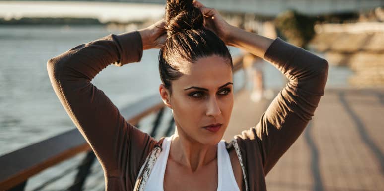 How To Do A Messy Bun: 11 Easy Tutorials woman doing a messy bun