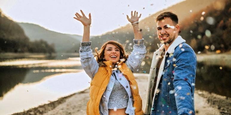 How The Full Moon Affects Zodiac Signs Personality Traits, Per Astrology couple throwing glitter