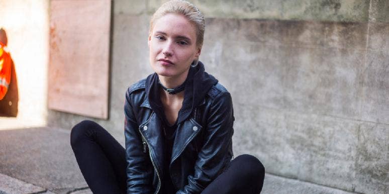 What Makes Each Zodiac Sign Feel Guilty, According To Astrology woman in leather jacket sitting