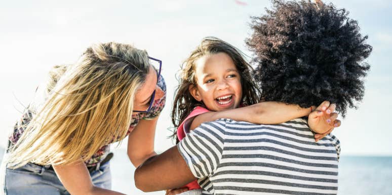 How parents' relationships affect choices as an adult family hugging on a beach