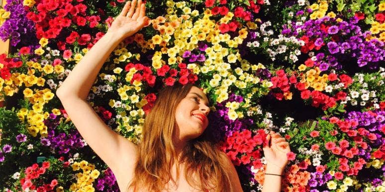 young woman laying in flowers