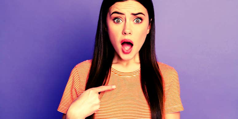 How To Stop Being Defensive In Your Relationship woman with shocked and defensive facial expression pointing at herself incredulously