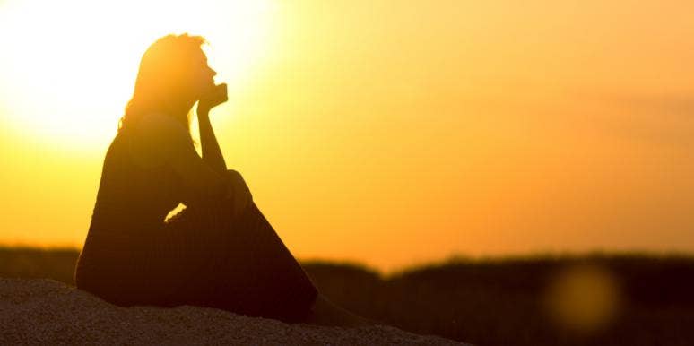 10 Secret Tricks To Be A Much More Intuitive Person woman sitting in sunset