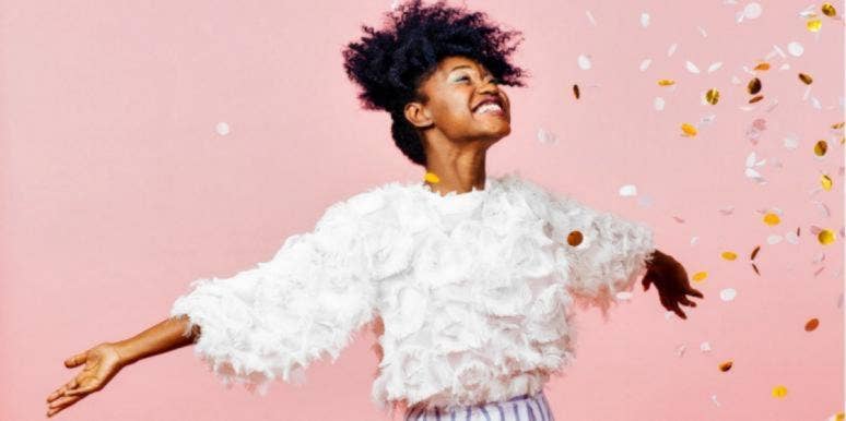 How to cleanse your aura jubilant woman celebrating in confetti