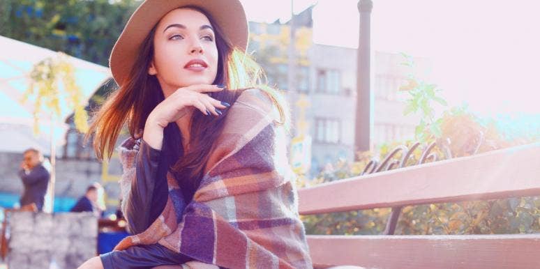 how to develop intuition woman in hat and scarf sitting outside on bench