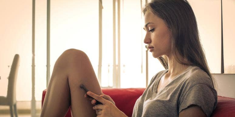 How To End A Friendship: 4 Tips, Texts & How To Know When It's Time woman sitting on couch texting