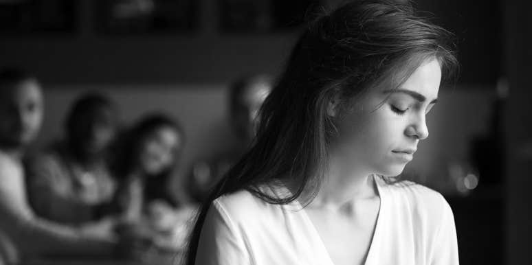 How To Survive A Breakup When You Have Mutual Friends sad woman with friends in background