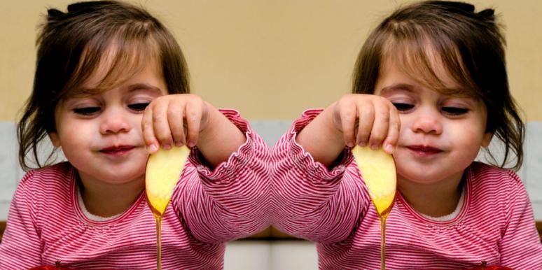 How To Greet Someone On Rosh Hashanah: Jewish New Year Quotes & Messages girl eating apples and honey on Rosh Hashanah