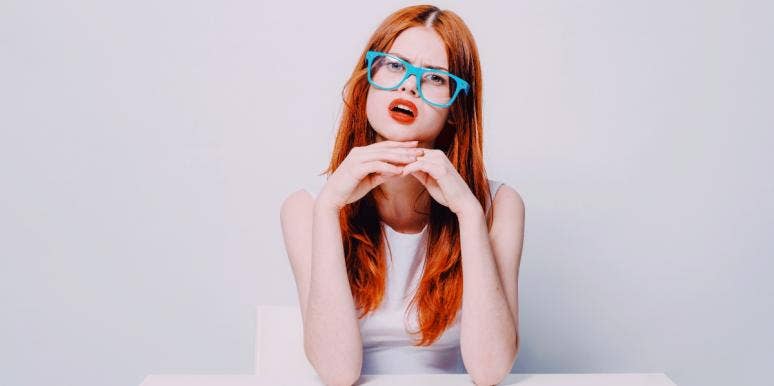 how to let go of regrets confused-looking woman in white in a white room