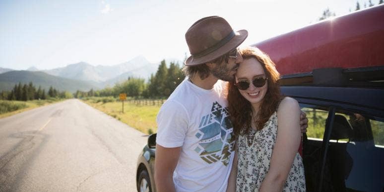 how to make your wife hapy man kissing woman's head against red car