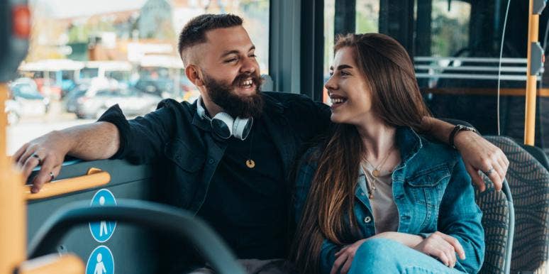 man and woman on bus laughing