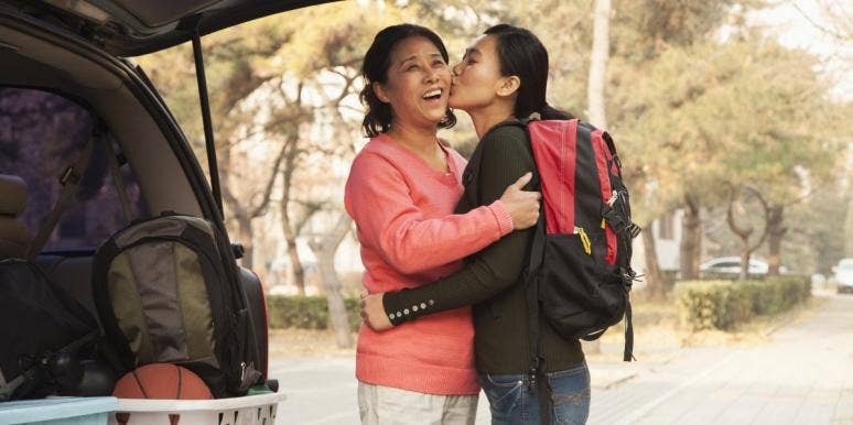 how to overcome empty nest young adult child going to college kissing mom on cheek