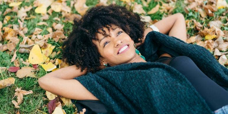 how to raise your vibration woman lying on the ground