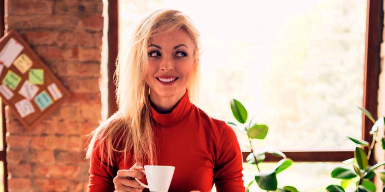 regulate emotions woman calmly smiling with tea