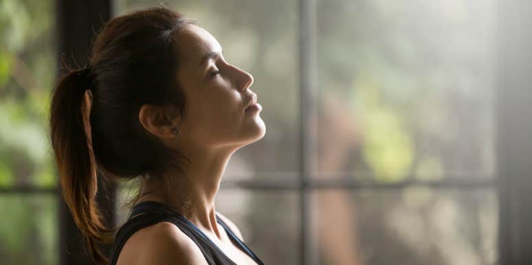 A 2-Minute Solution To Feeling Less Stressed When Even Just Thinking About It Is Too Stressful woman doing breathing exercise