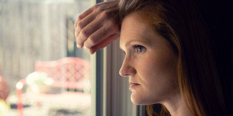 woman looking out the window thinking about negative feedback