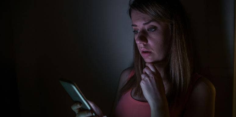 Internet Trolls Are Narcissists, Psychopaths And Sadists, Says Study woman looking at phone in the dark