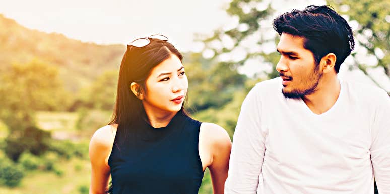 5 Ways To Calm Down When You're Mad At Your Partner young Asian couple looks at one another in sunlight
