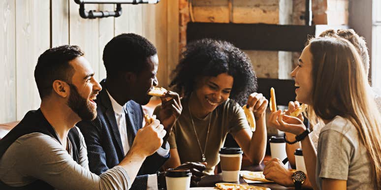 How To Lead A Conversation About Race racially diverse group of adults talking over pizza dinner