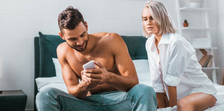 Is He Cheating Or Am I Paranoid? How To Tell For Sure man texting with jealous woman