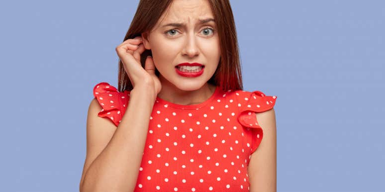 How To Tell Someone You're Just Not Interested awkward woman in red shirt with purple background