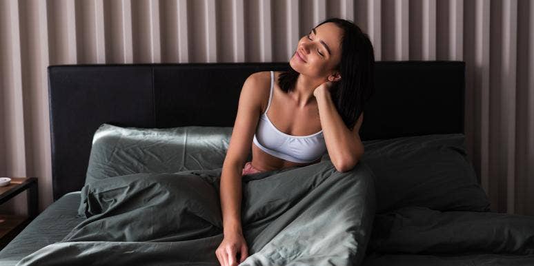 The Best Time To Wake Up When You Have Depression, According To Science woman waking up in bed