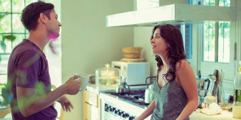 man and woman talking in the kitchen