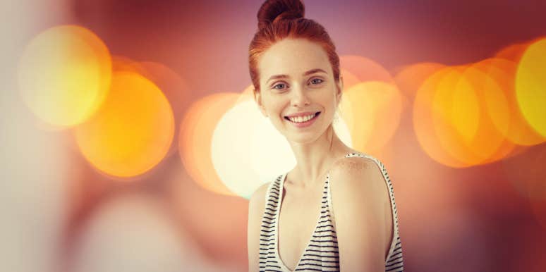 red-haired woman with lights behind her 