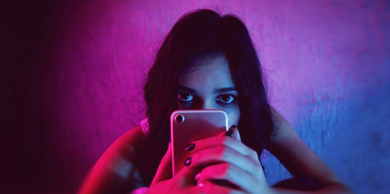 The Strange Reason I Facebook-Stalk My Ex's New Girlfriend woman using her phone