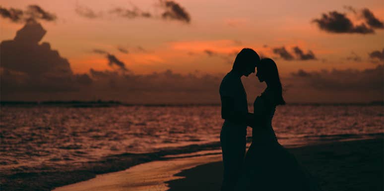 couple in sunset by ocean