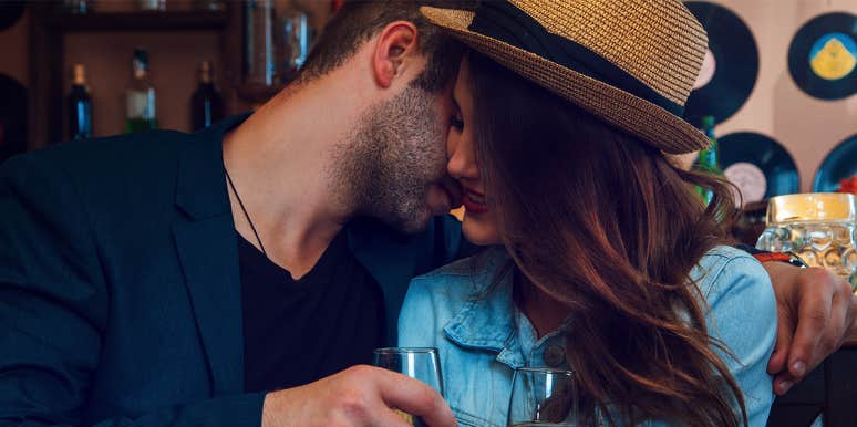 5 Shady Signs You're Dating A Pick-Up Artist man whispering to woman
