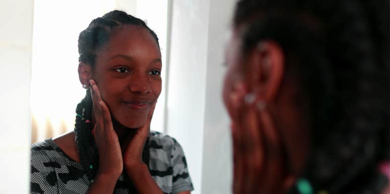 I’m Not Perfect But I Can Finally See The Beauty In Myself woman smiling in the mirror