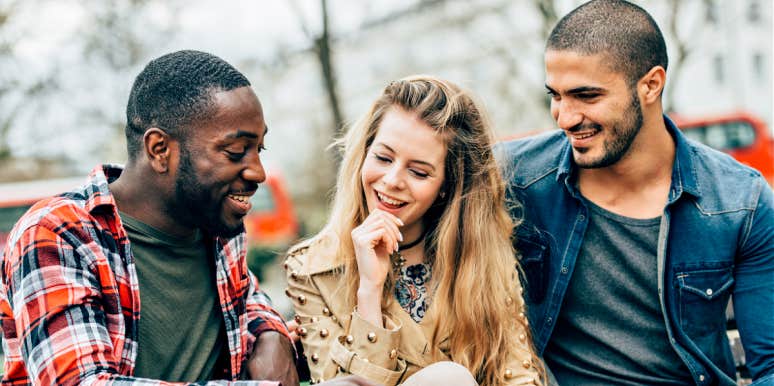 In love with two men at the same time a woman seated between two men who are both interested in her