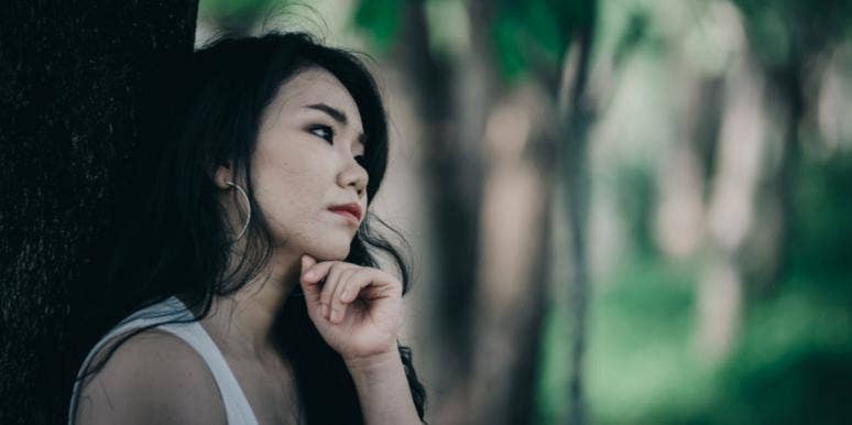 I Dated Someone Who Was Secretly In Love With Somebody Else woman sad next to tree