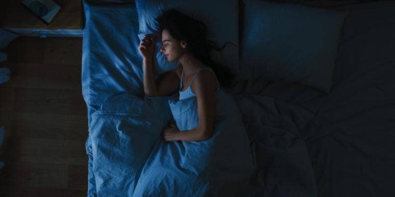 The Breathing Trick That Beats Insomnia In 60 Seconds Flat woman sleeping soundly on her side in bed