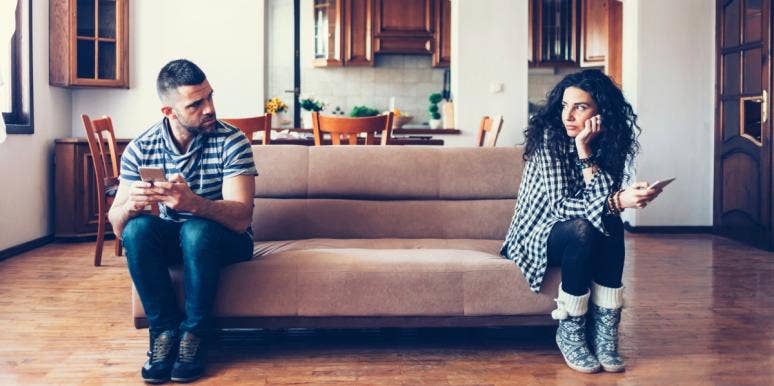 is your spouse cheating? sad couple sitting on couch