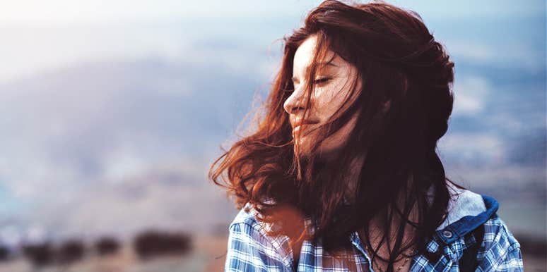 Why people have January blues woman with dark reddish hair has a pensive winter thought, in the wind
