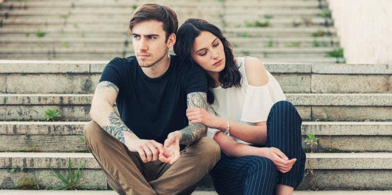 karmic relationships man and woman sitting on stairs