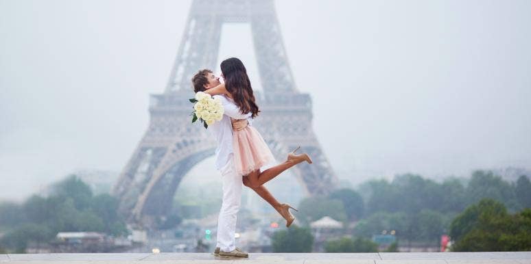 keeping a long-term relationship alive man with woman in his arms in front of the Eiffel tower
