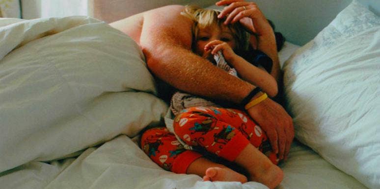 kid laying with parent kid laying with parent