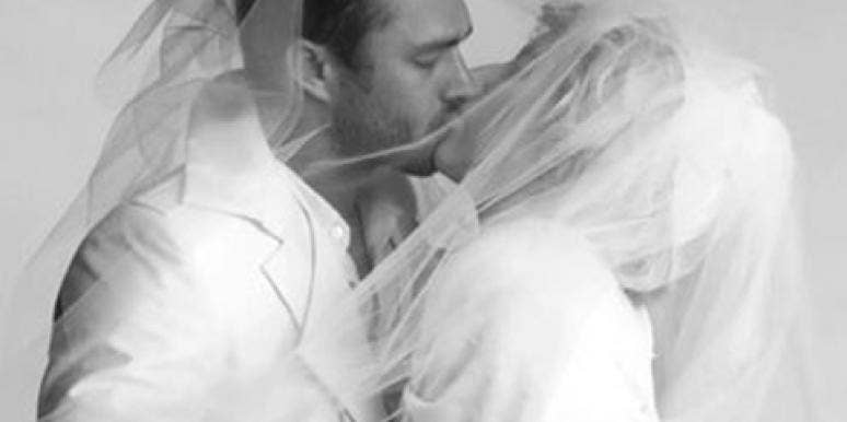 Taylor Kinney and Lady Gaga, rumored to be engaged, kiss under a veil in a black and white wedding-themed photo
