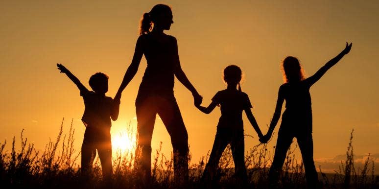 Study Says Parents With Large Families Are The Happiest mom with three kids silhouette