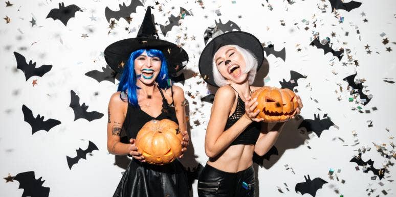 girls dressed in costumes holding pumpkins
